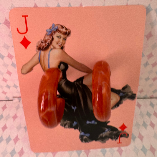 Playing card with a vintage-style illustration of a woman on a pink background
