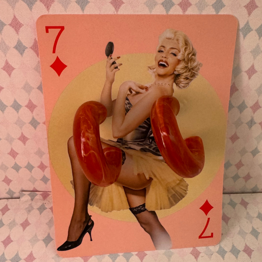 Playing card with a stylized illustration of a woman holding a phone, on a patterned background.