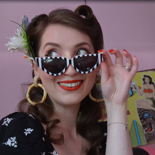 Woman wearing sunglasses with a colorful background